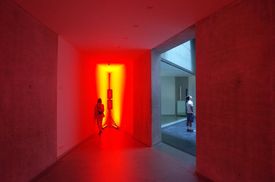 A photo showcasing the interior of a contemporary art museum with people admiring different artworks.